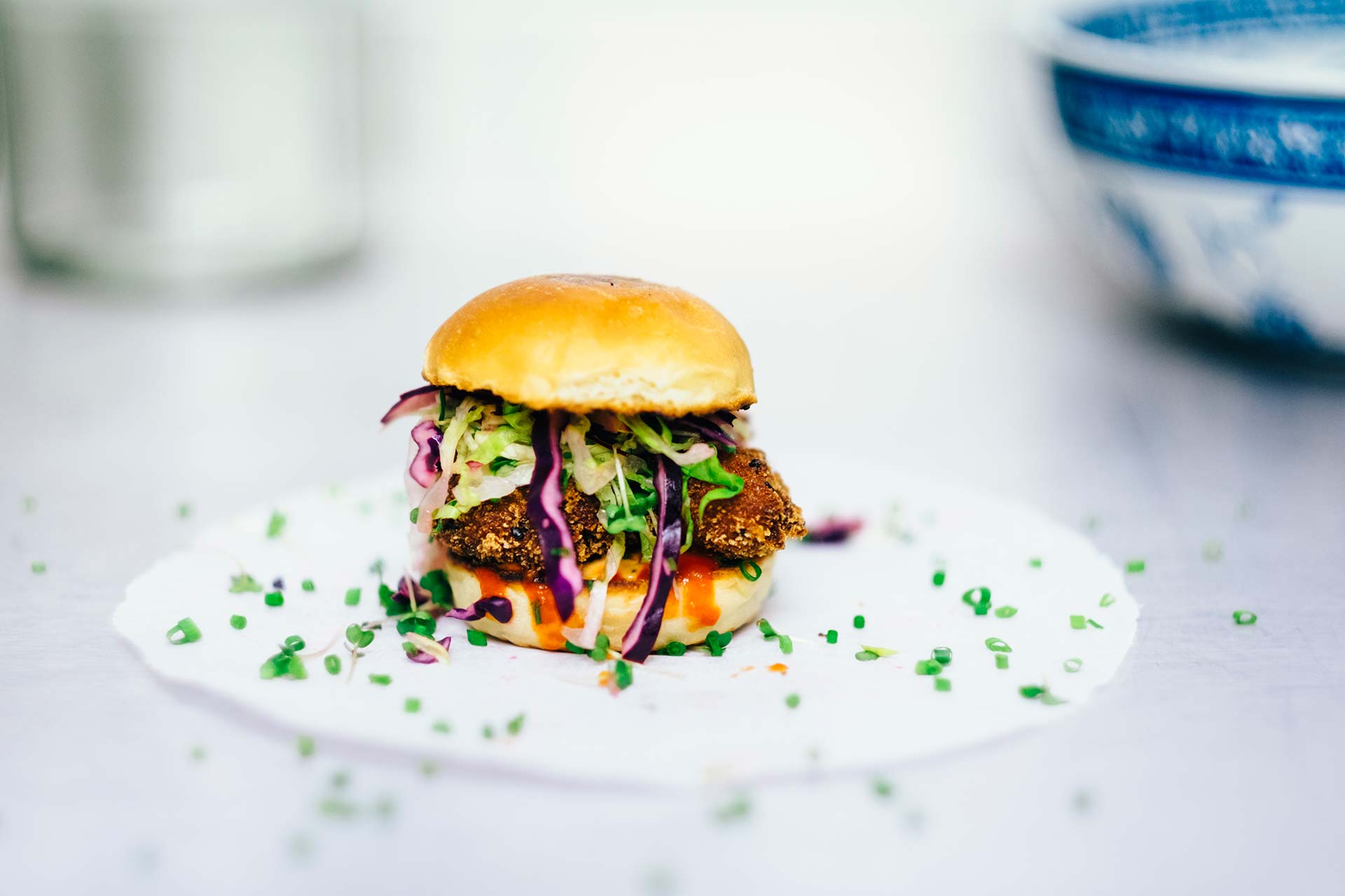 Gourmet slider with colorful vegetables and herbs.
