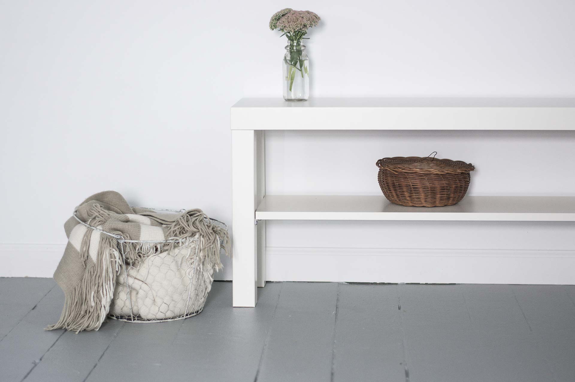 White table with basket and flowers.