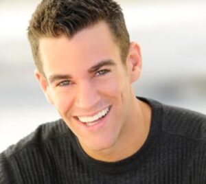 Smiling man in a black sweater.