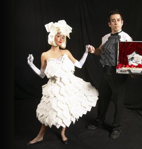 Couple in creative paper-themed costumes posing.