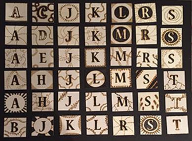 Alphabet tiles with decorative designs.