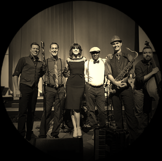 Band posing with instruments on stage.