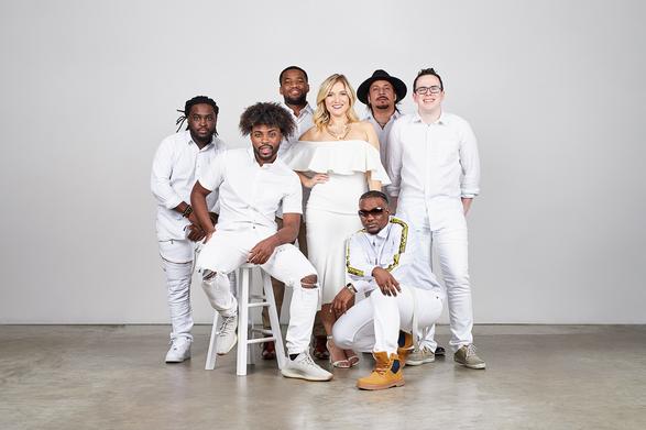 Group posing in matching white outfits.