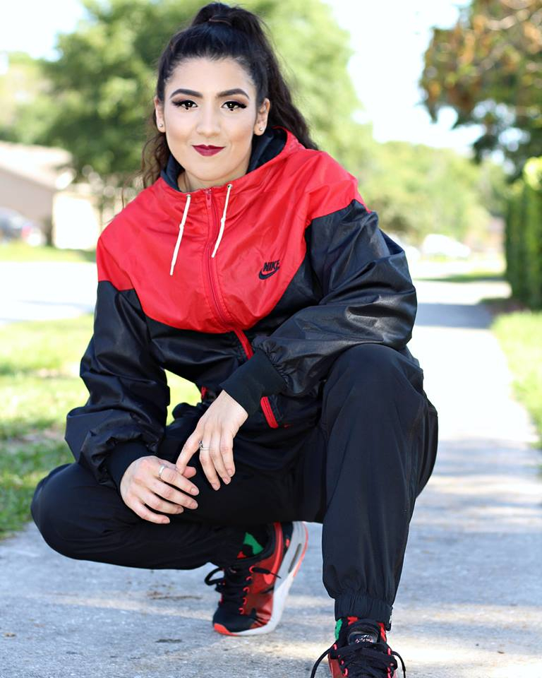 Person in red and black sports outfit.