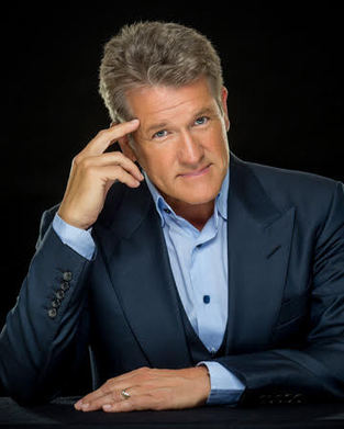 Man in suit posing with thoughtful expression.