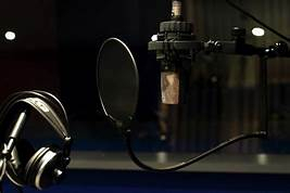 Microphone and headphones in recording studio setup.