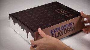 A person is opening up an explosive flavor box.