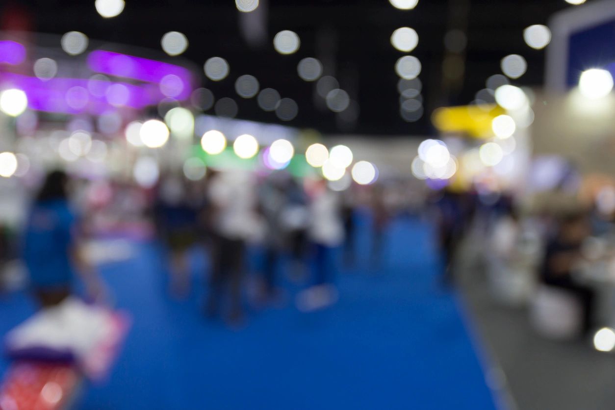 Blurry image of people at a convention.